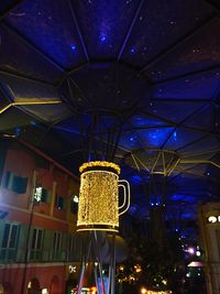 Low angle view of illuminated lamp in city at night