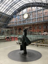 Rear view of woman walking at railroad station