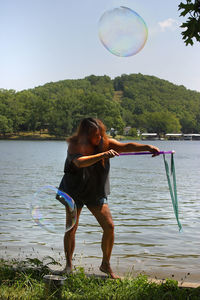 Full length of woman making bubbles