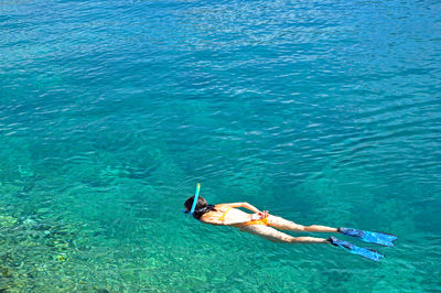 High angle view of woman snorkeling in sea