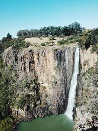 Scenic view of waterfall against sky