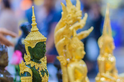 Close-up of buddha statue against building