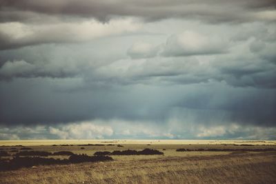 Scenic view of storm clouds over land