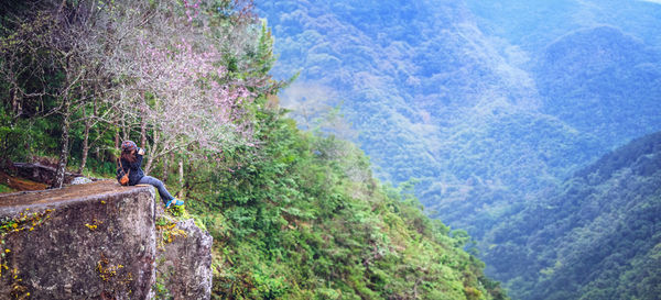 Rear view of man climbing on mountain