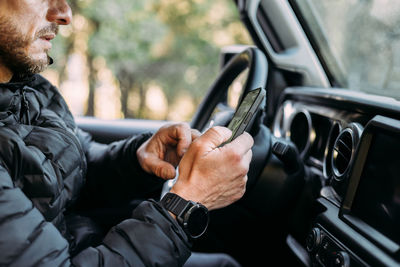 Midsection of man driving car