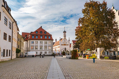 Street amidst buildings against sky in city