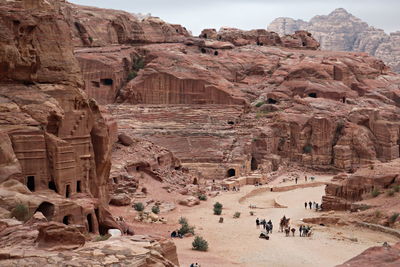 High angle view of people and animals by rock formations