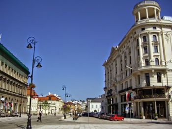 View of city street against blue sky