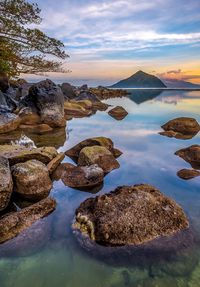 Scenic view of rocks in lake against sky