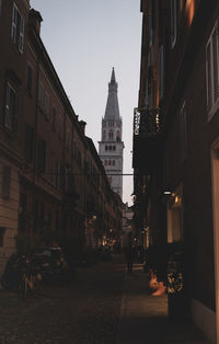 Street amidst buildings against sky in city