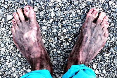 Low section of person standing on tiled floor