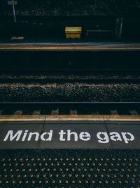 High angle view of text on railroad station platform