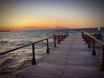 Pier over sea against clear sky