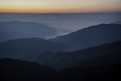 Scenic view of silhouette mountains against sky during sunset
