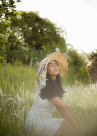 Young woman in hat on field