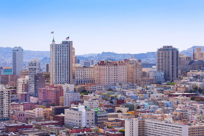 Modern buildings in city against clear sky