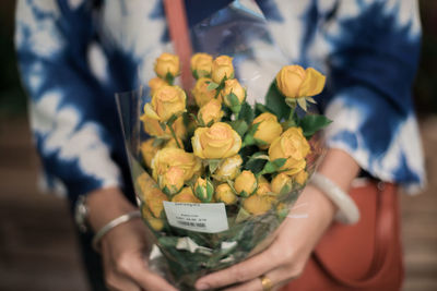 Close-up of hand holding flower bouquet