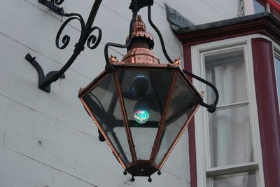 Low angle view of electric lamp against sky