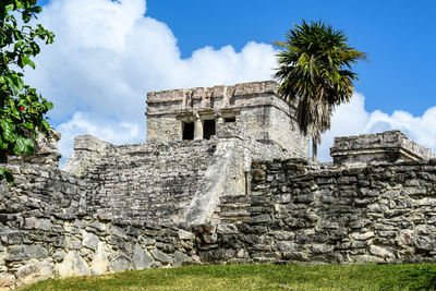 Low angle view of old building against cloudy sky