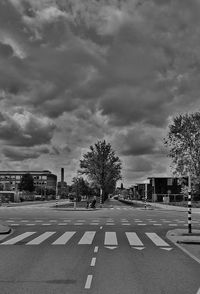 Empty road against cloudy sky