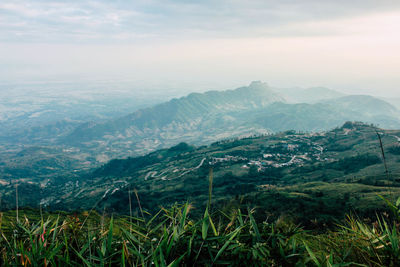 Scenic view of valley and mountains against sky