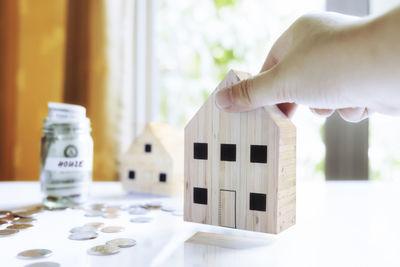 Close-up of hands holding model home