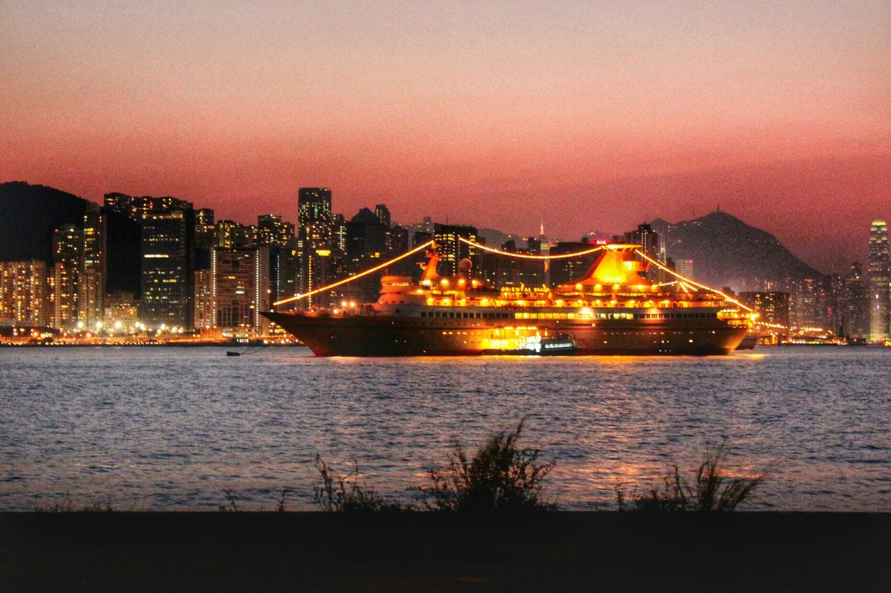 illuminated, architecture, built structure, water, building exterior, city, night, river, cityscape, bridge - man made structure, sky, connection, waterfront, sea, reflection, sunset, clear sky, copy space, dusk, city life