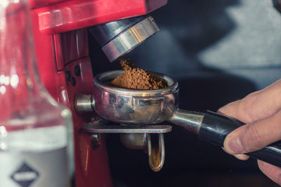 Close-up of hand holding coffee cup