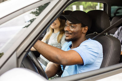 Young man sitting in car