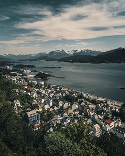 High angle view of townscape by sea against sky