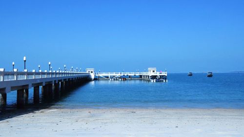 Scenic view of sea against clear blue sky