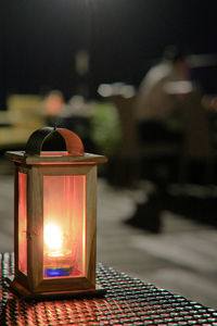 Close-up of illuminated lantern on table