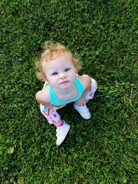 Portrait of cute baby girl on field