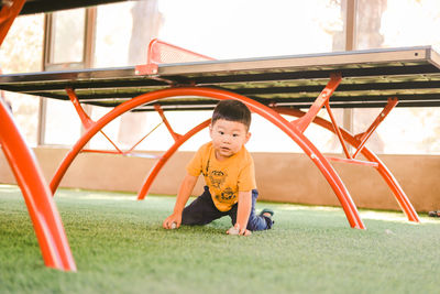 Full length of boy playing on slide at playground