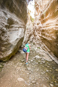 Rear view of boy standing on rock