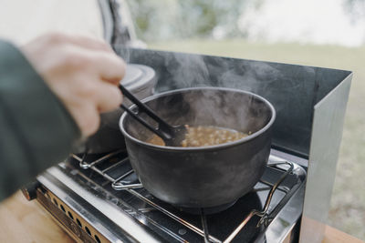 Midsection of person preparing food in kitchen