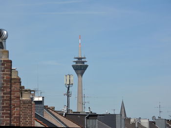 Low angle view of communications tower against sky