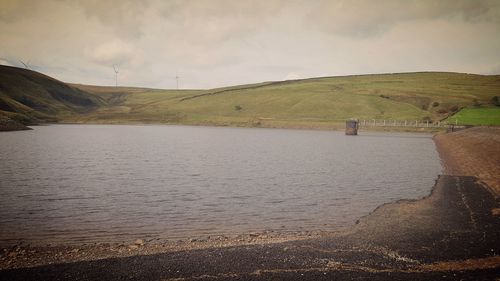 Scenic view of lake against cloudy sky