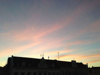 High section of building against sky at sunset