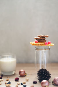 Close-up of milk and cookies with christmas decorations on table