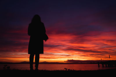 Observing a beautiful sunset full of warm colors near the lake shore