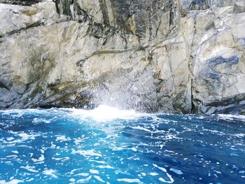 Scenic view of sea against rocks