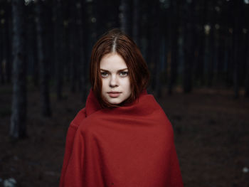 Portrait of beautiful young woman in forest