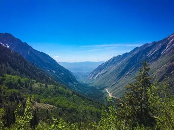 Scenic view of mountains against blue sky