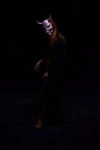 Digital composite image of cat against black background