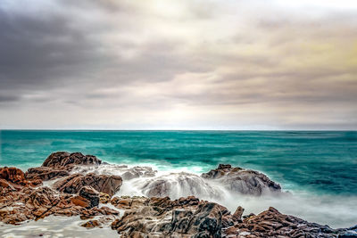 Scenic view of sea against cloudy sky