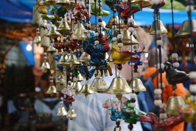Close-up of wind chimes hanging in store for sale