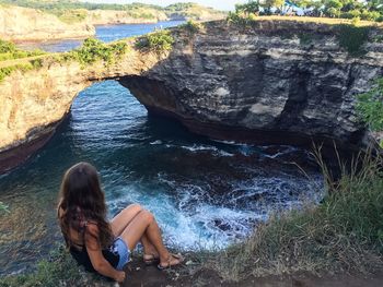 High angle view of girl sitting against river