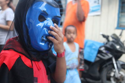 Rear view of boy standing on mask