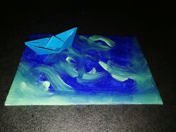 Close-up of multi colored paper over black background